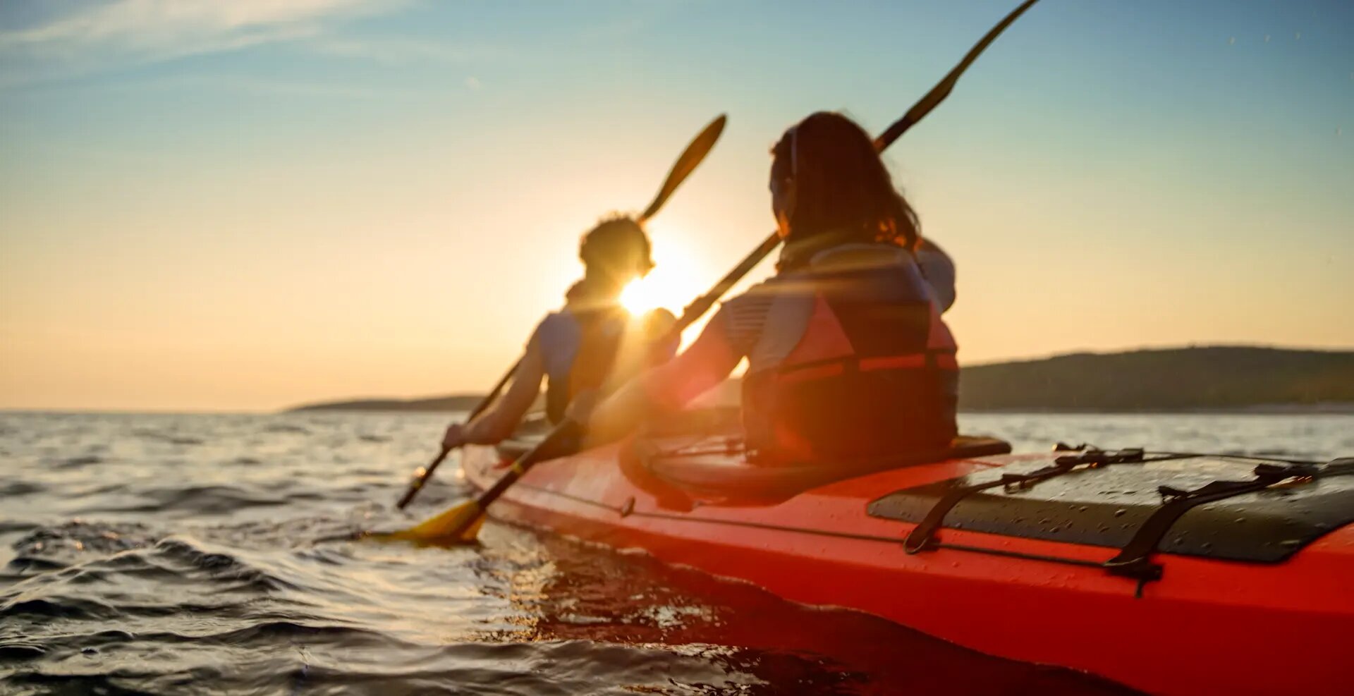 Kayak on still water at sunrise